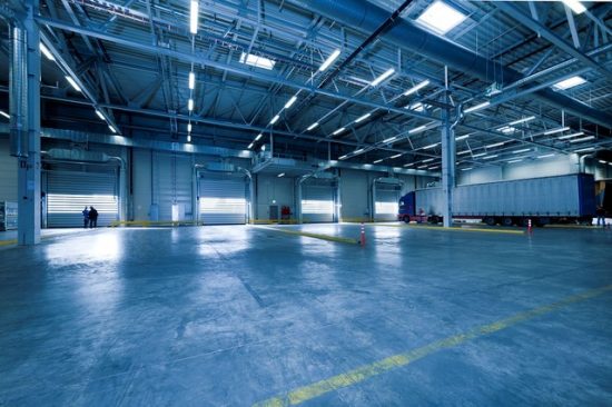 A large industrial warehouse with lighting installed.
